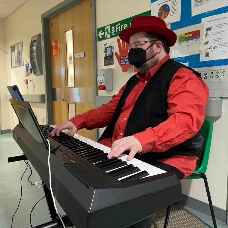 Christopher Lydon performing solo piano on a hospital ward