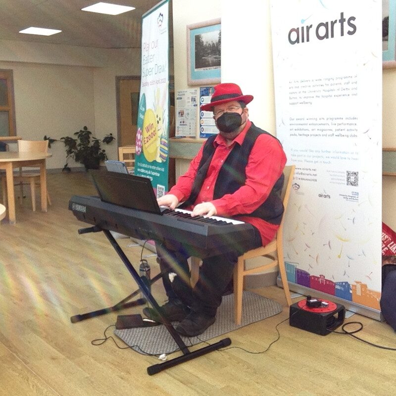 Christopher Lydon performing solo piano in a hospital waiting area