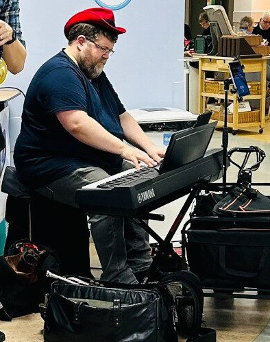 Christopher Lydon performing solo piano on a hospital ward